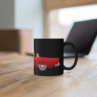 Black Coffee Mug with A Red Thunderbird on a table with laptop